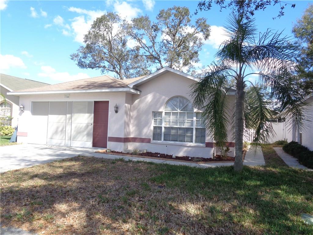 7744 Chadwick Drive New Port Richey, FL 34654 - Photo 1 of 1 a front view of a house with a yard