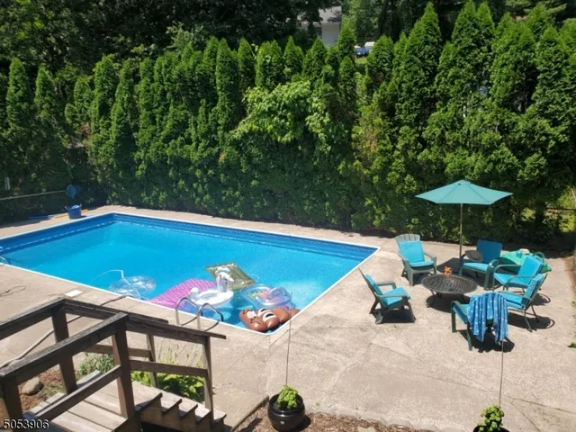 a view of swimming pool with a table and chairs