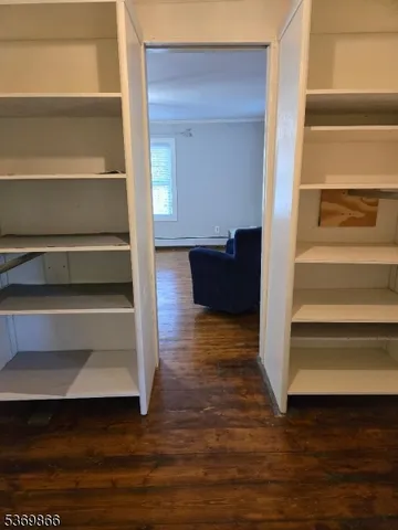 a view of walk in closet with empty racks