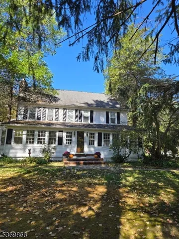 a front view of a building with street view and trees