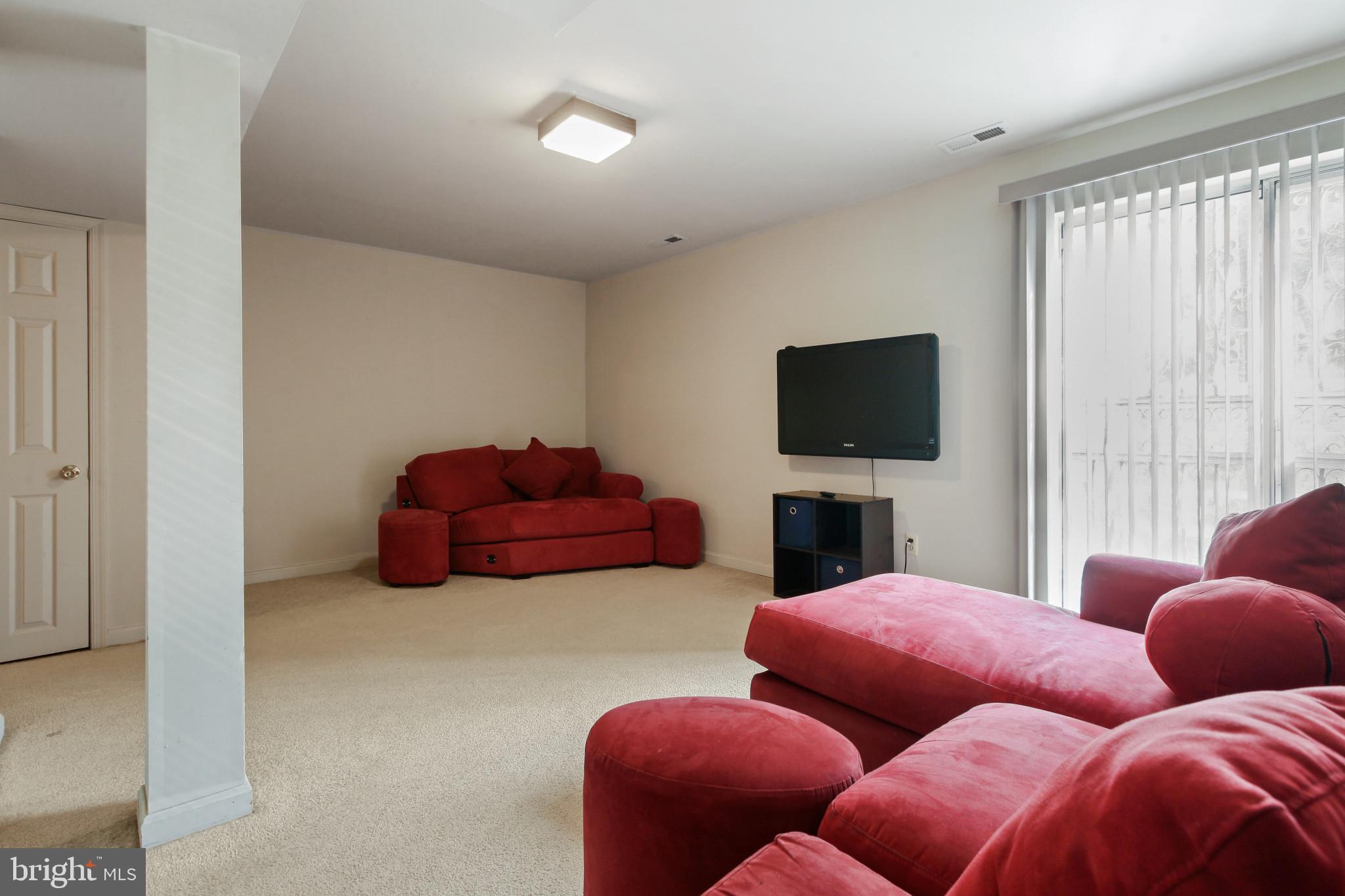15 Tameron Place Rosedale, MD 21237 - Photo 26 of 38 a living room with furniture and a flat screen tv