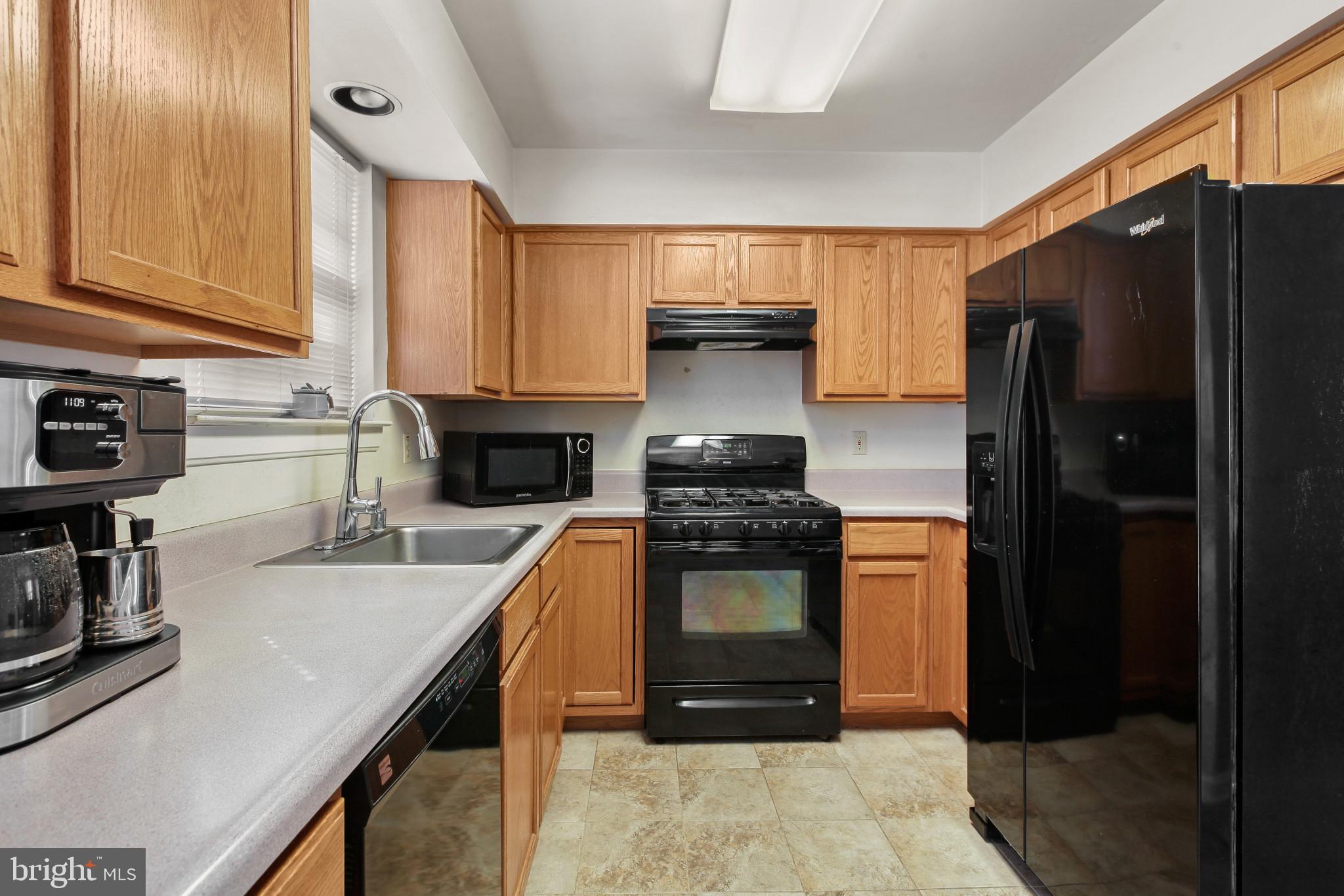 15 Tameron Place Rosedale, MD 21237 - Photo 10 of 38 a kitchen with granite countertop a refrigerator and a stove