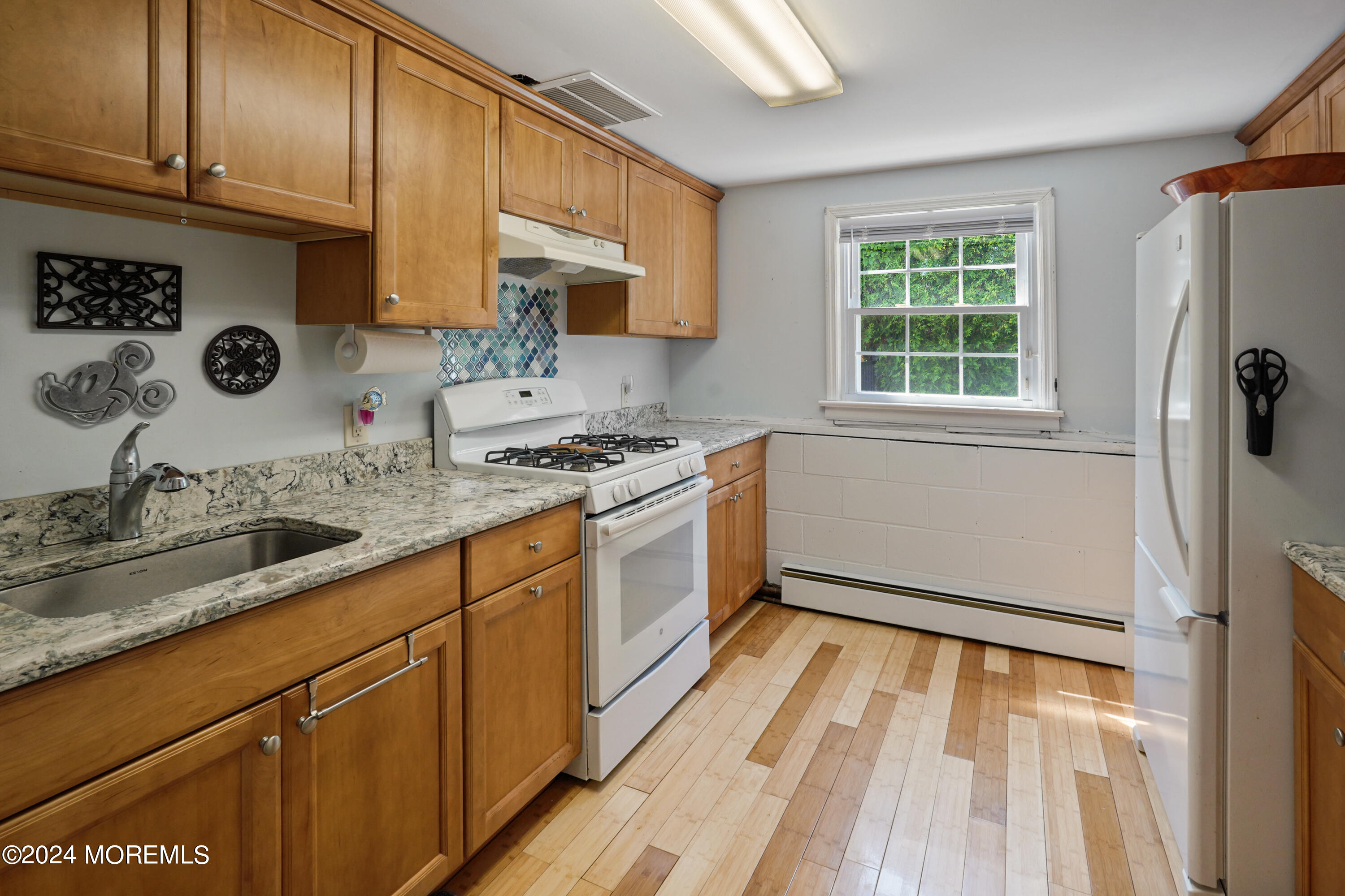 403 Union Lane Brielle, NJ 08730 - Photo 31 of 31 a kitchen with a sink a stove and cabinets