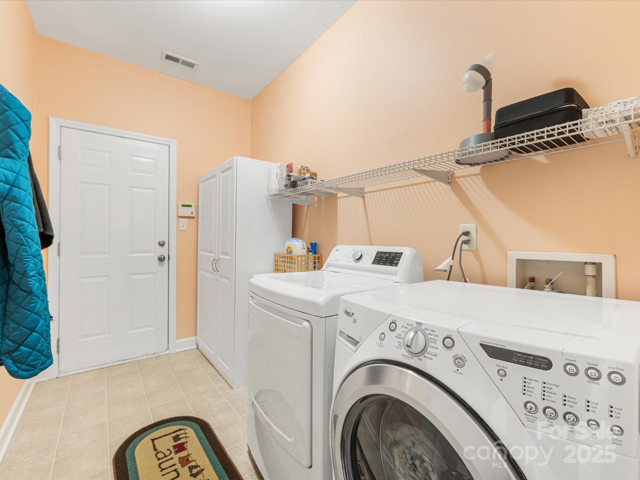4434 Patriots Hill Road Mint Hill, NC 28227 - Photo 19 of 31 a view of washer and dryer with kitchen in the background