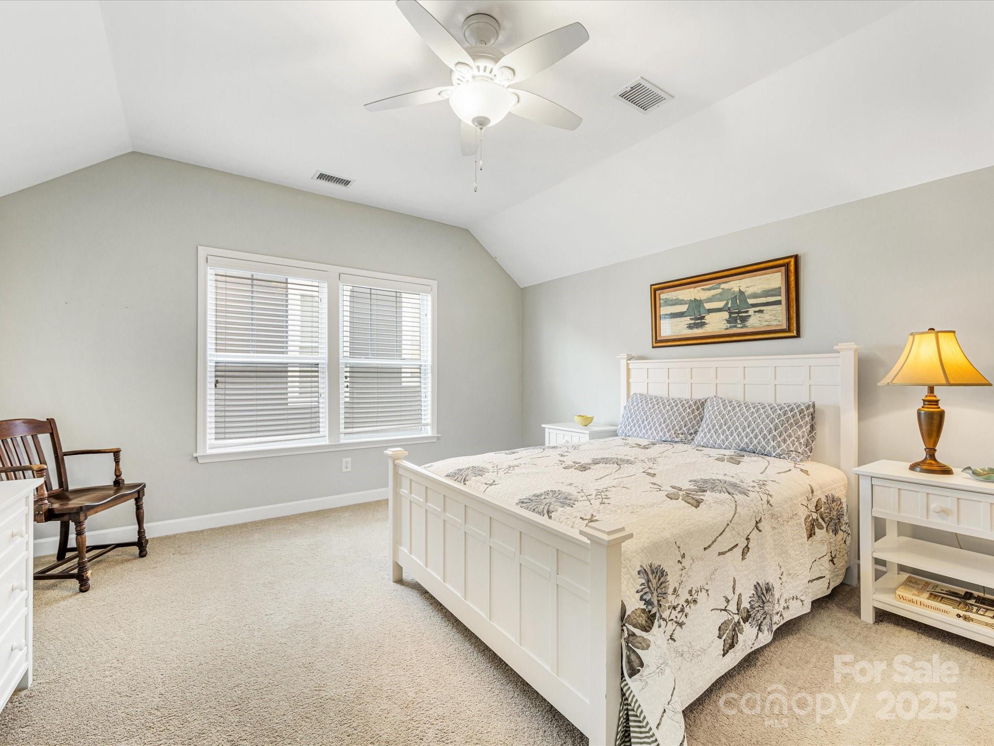 4434 Patriots Hill Road Mint Hill, NC 28227 - Photo 20 of 31 a bedroom with a bed and a chandelier