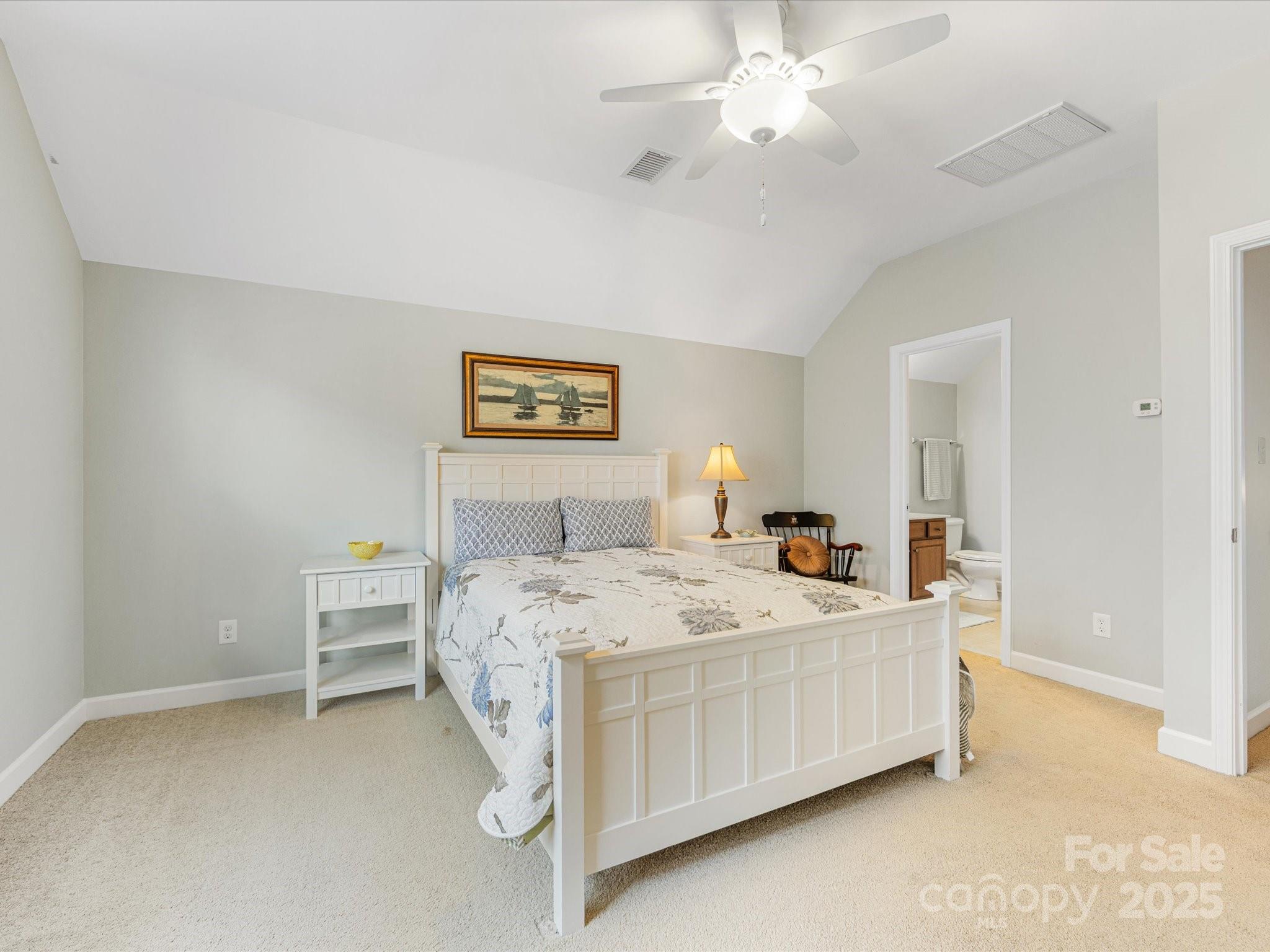 4434 Patriots Hill Road Mint Hill, NC 28227 - Photo 21 of 31 a bedroom with a bed and a chandelier