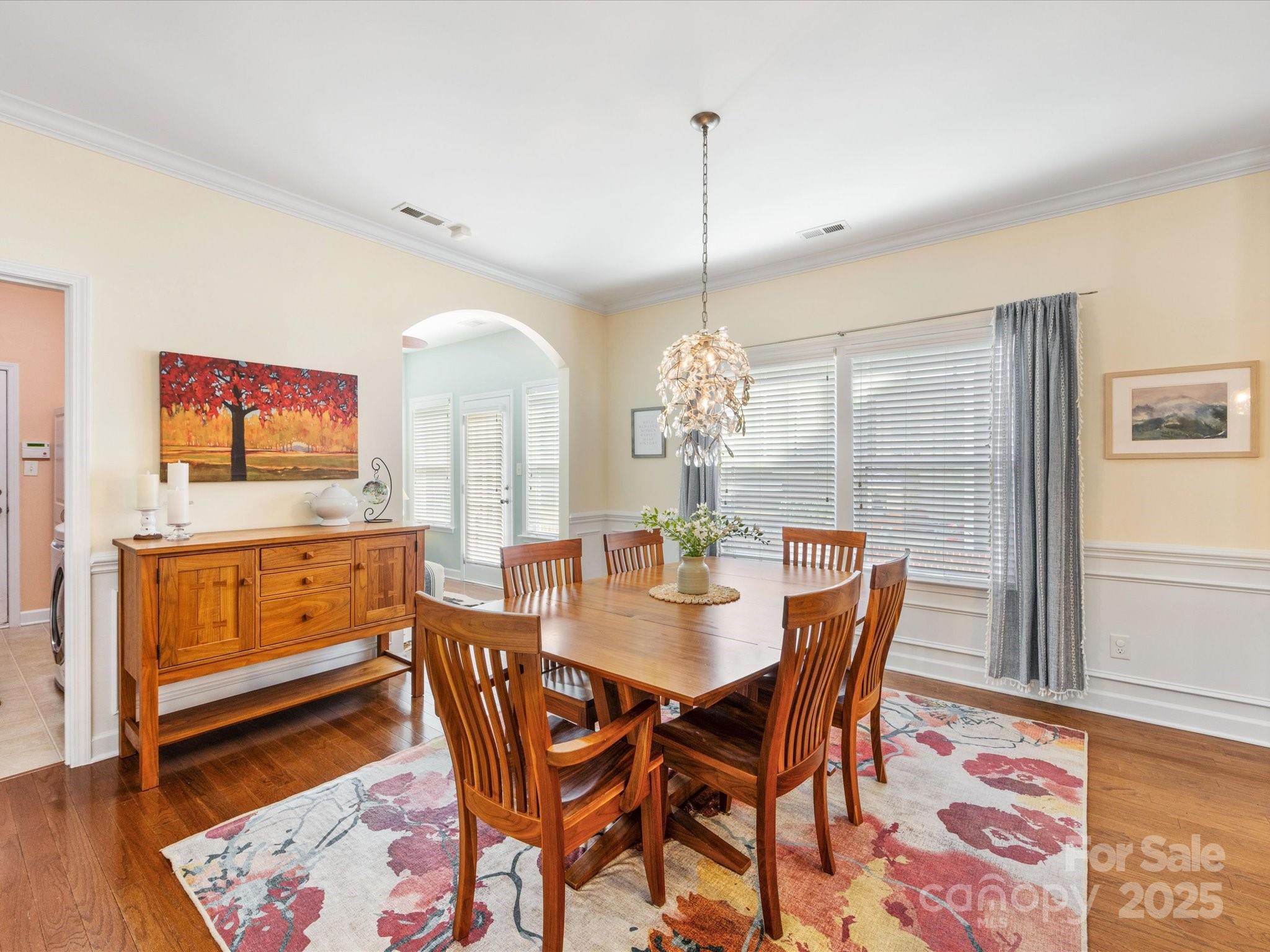 4434 Patriots Hill Road Mint Hill, NC 28227 - Photo 9 of 31 a dining room with furniture a chandelier and wooden floor