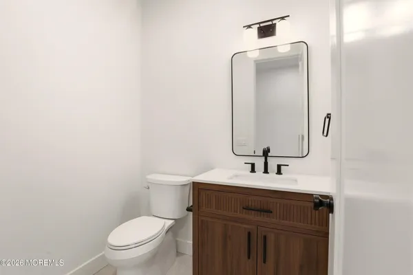a bathroom with a sink toilet vanity and bathtub
