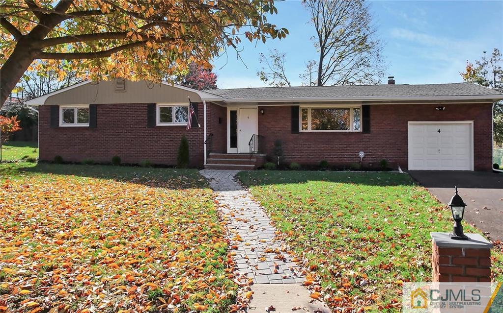 4 Carpender Road New Brunswick, NJ 08901 - Photo 2 of 21 a front view of a house with a yard and garage