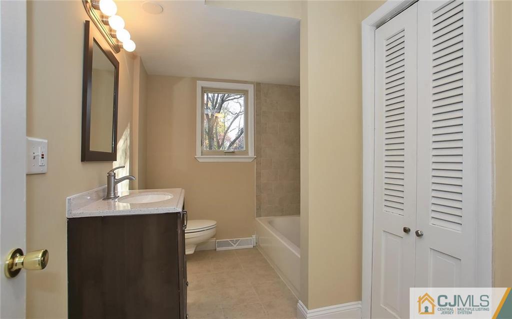 4 Carpender Road New Brunswick, NJ 08901 - Photo 13 of 21 a bathroom with a sink a toilet and shower