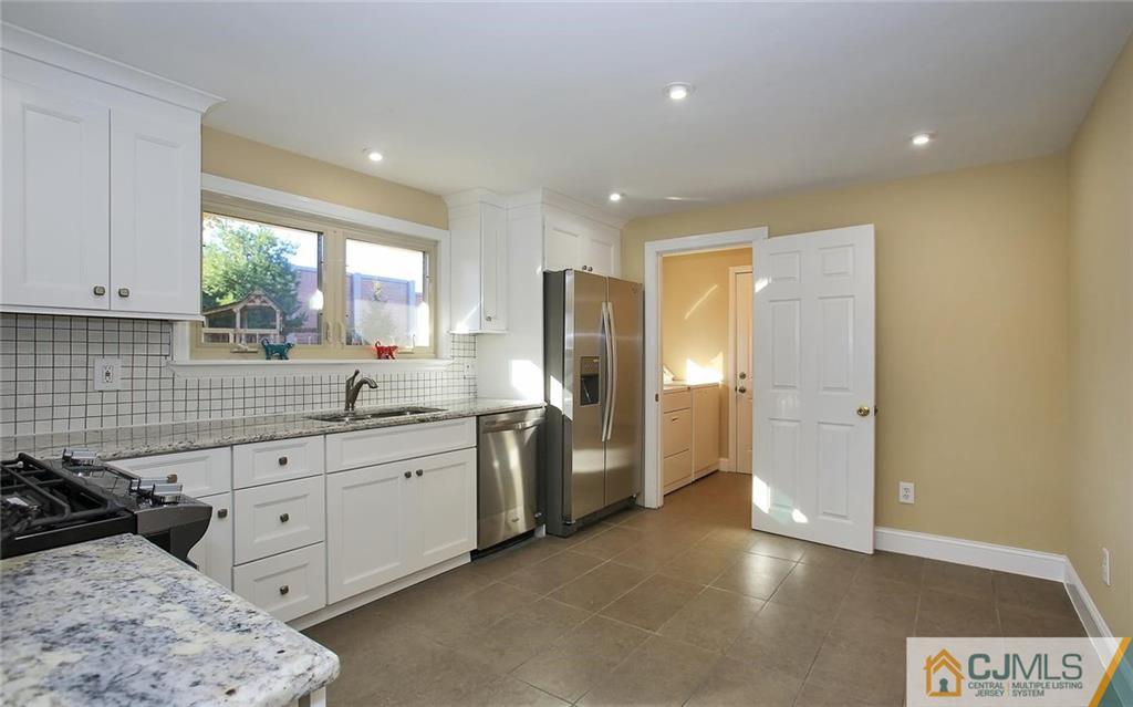 4 Carpender Road New Brunswick, NJ 08901 - Photo 9 of 21 a kitchen with a sink and a refrigerator