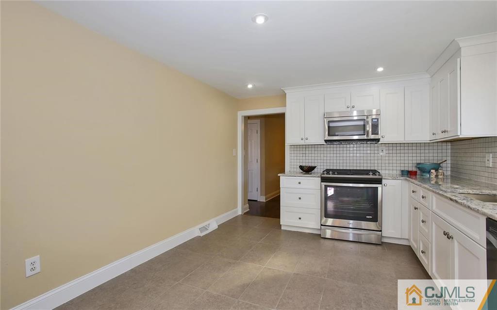 4 Carpender Road New Brunswick, NJ 08901 - Photo 10 of 21 a kitchen with a sink a stove and cabinets