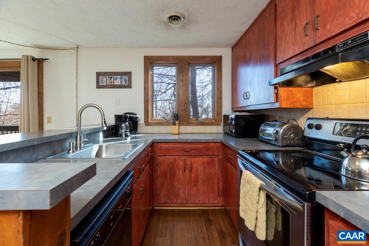 420 3 Ridges Wintergreen, VA 22967 - Photo 3 of 16 a kitchen with granite countertop a stove and a sink