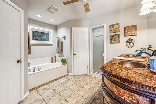 a bathroom with a sink a bathtub and a shower