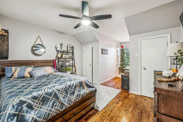 a bedroom with a bed and a flat tv screen on dresser