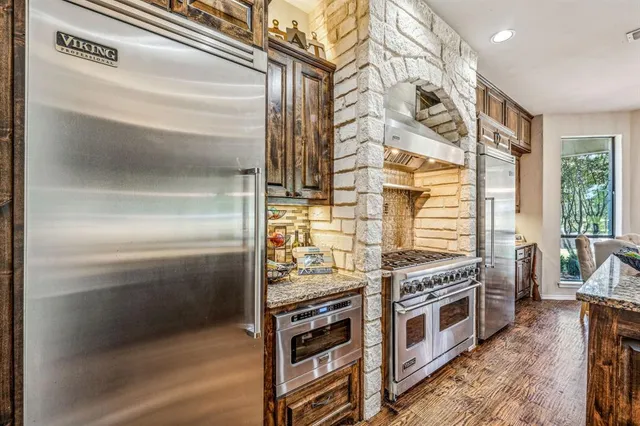 a kitchen with stainless steel appliances and cabinets