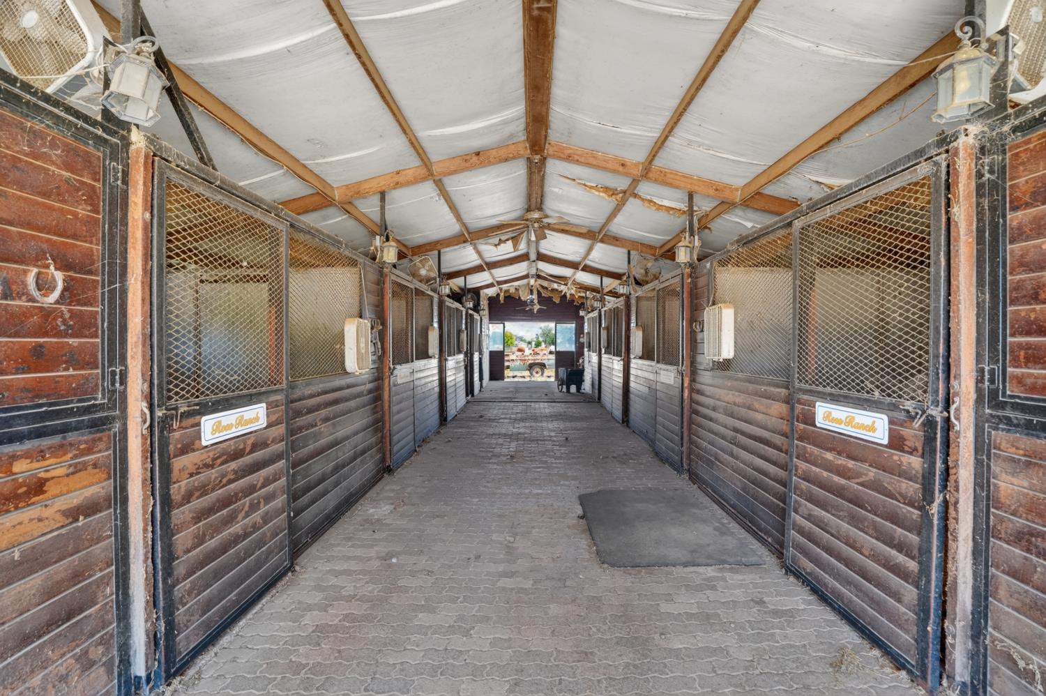 24390 North Jack Tone Road Acampo, CA 95220 - Photo 3 of 40 Show barn 10-12x12 stalls. Wash rack and tack room.