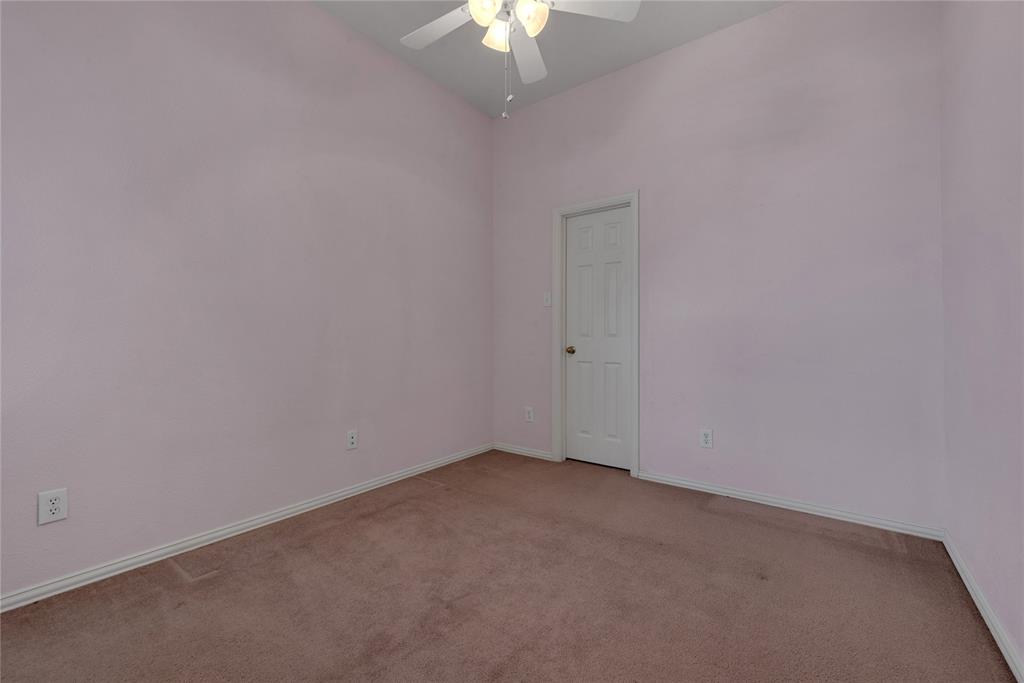 910 Derby Court Celina, TX 75009 - Photo 22 of 27 an empty room with a chandelier fan and closet