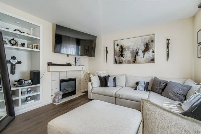 a living room with furniture a flat screen tv and a fireplace