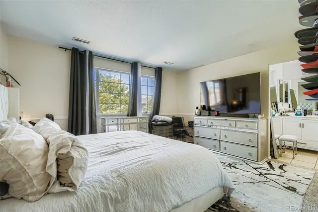 a bedroom with a bed and flat screen tv