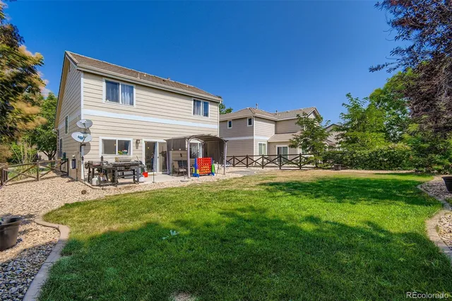 a view of a house with backyard and porch