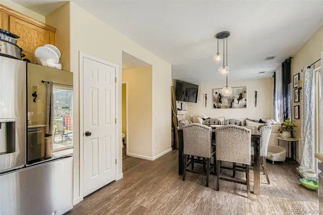 a dining room with furniture and wooden floor