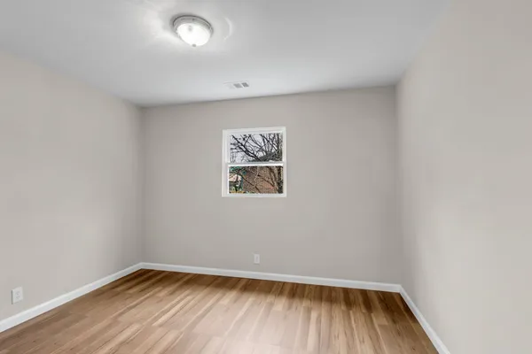 a view of room with wooden floor and fan
