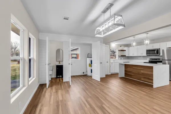 a view of kitchen with cabinets and wooden floor