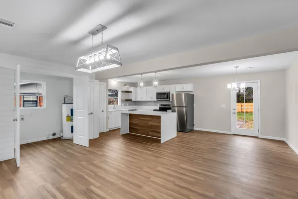 a view of kitchen with cabinets and wooden floor