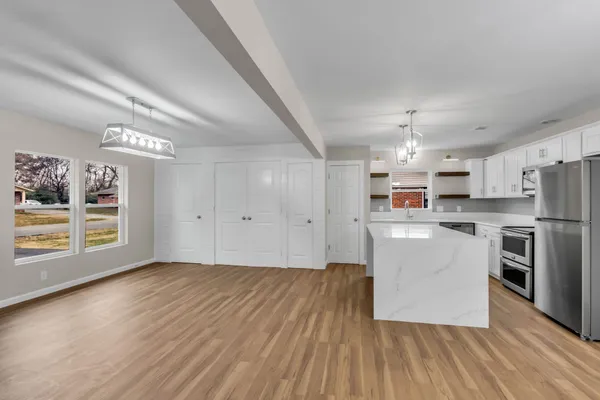a kitchen with cabinets and wooden floor