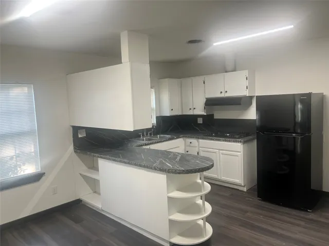 a kitchen with a refrigerator and a sink