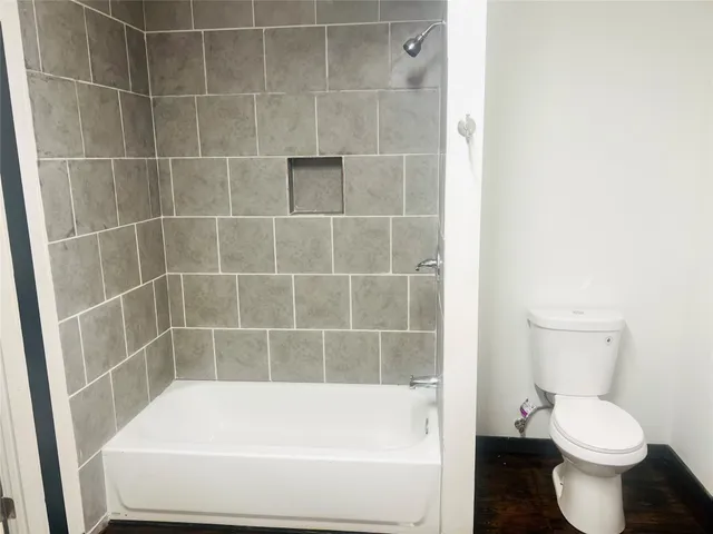 a bathroom with a bathtub and toilet