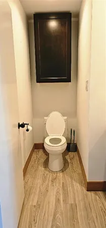 a bathroom with a toilet and a mirror