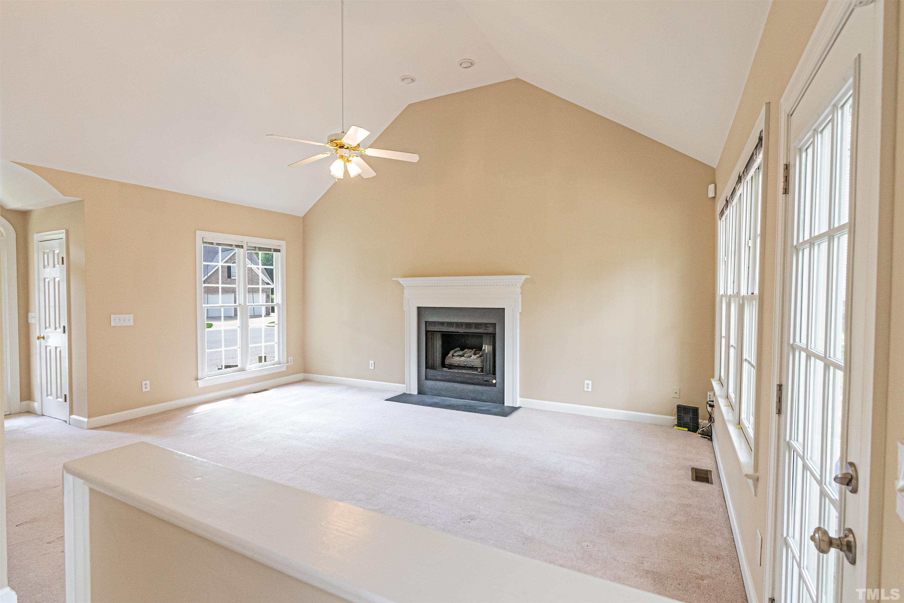 2505 Sugar Maple Court Raleigh, NC 27615 - Photo 7 of 41 a view of an empty room with a fireplace and a window