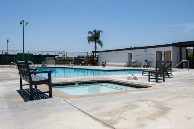 a view of a swimming pool and outdoor seating