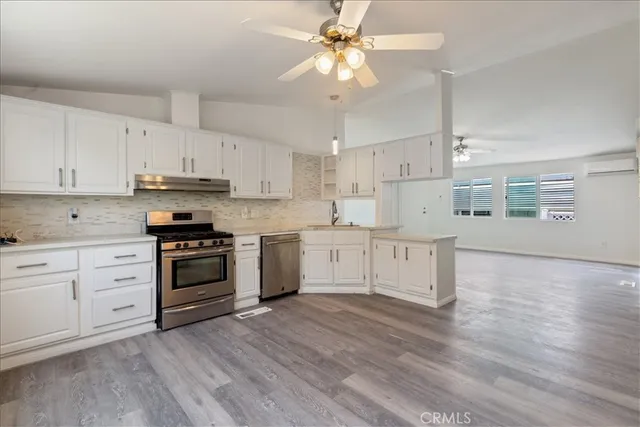 a kitchen with stainless steel appliances and white cabinets