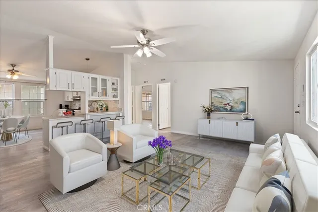 a living room with furniture and kitchen view