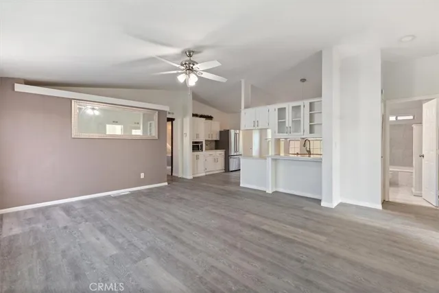 a view of a kitchen with wooden cabinet and a ceiling fan