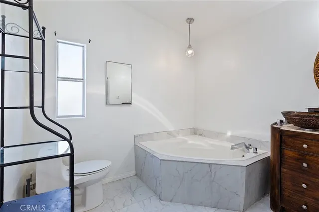 a bathroom with a bathtub a toilet and a shower