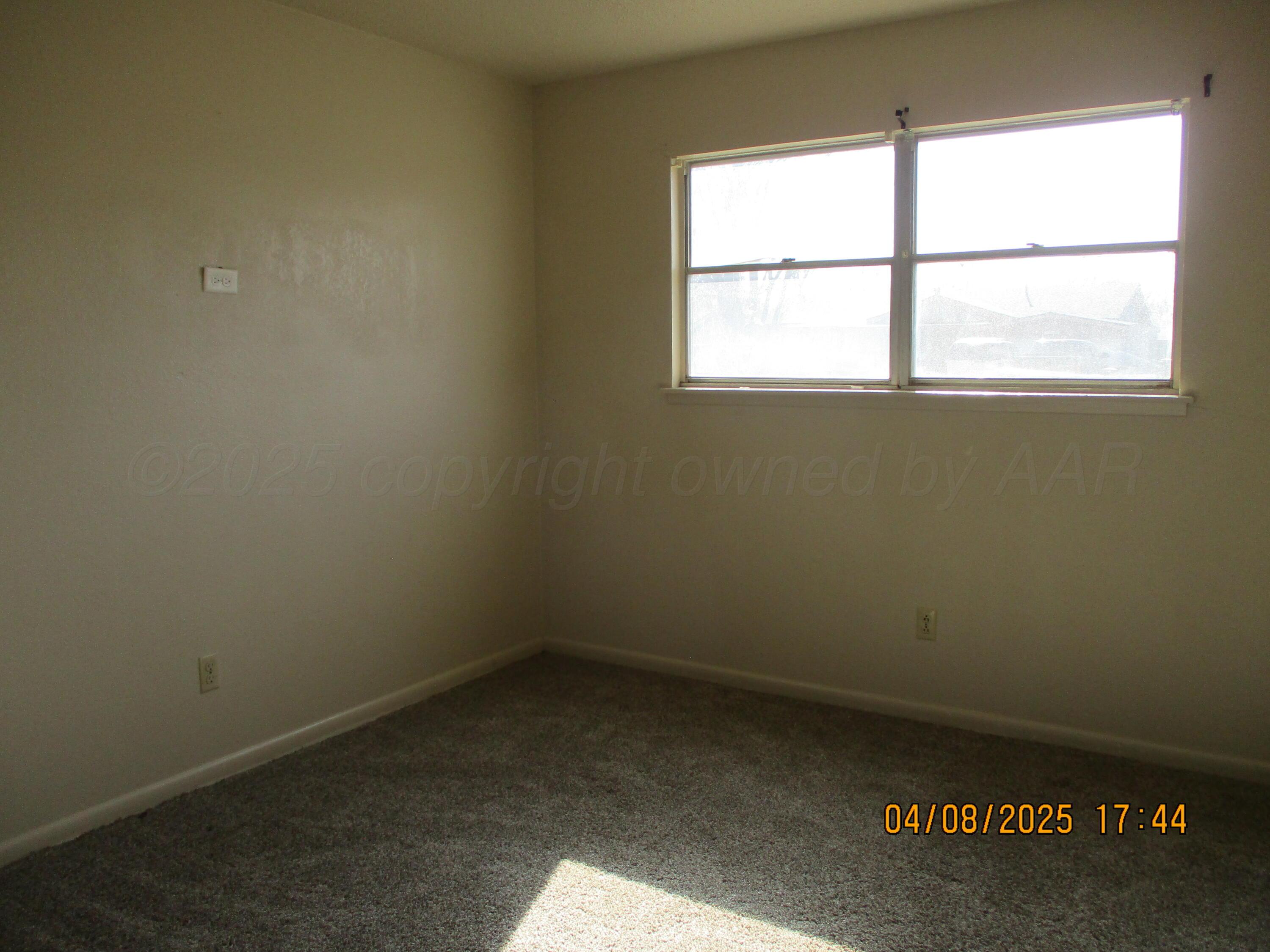 2913 Ricks Street Amarillo, TX 79103 - Photo 11 of 14 an empty room with a window