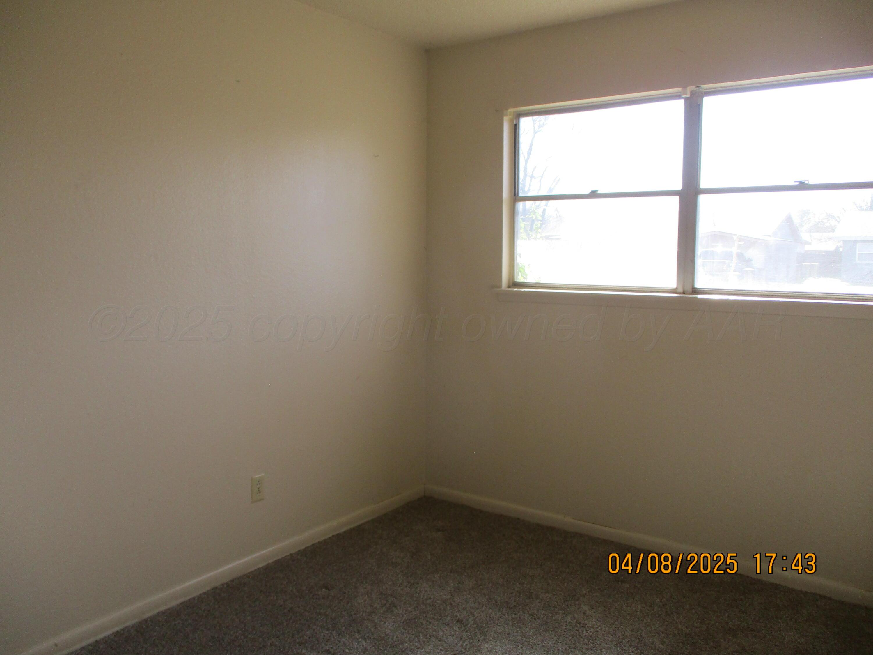 2913 Ricks Street Amarillo, TX 79103 - Photo 5 of 14 an empty room with a window