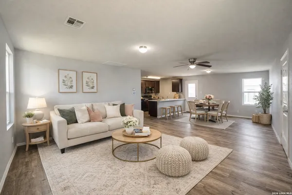 a living room with furniture potted plant and a table