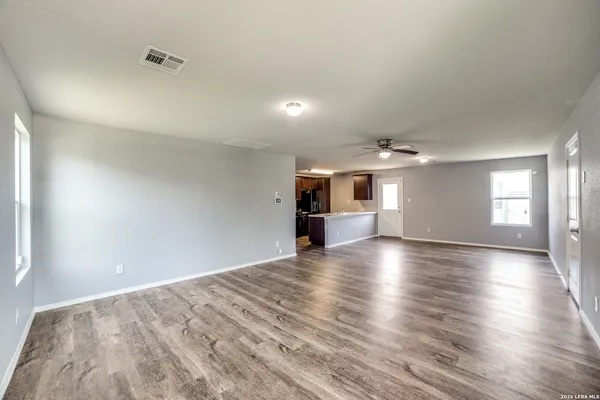 wooden floor in an empty room with a window