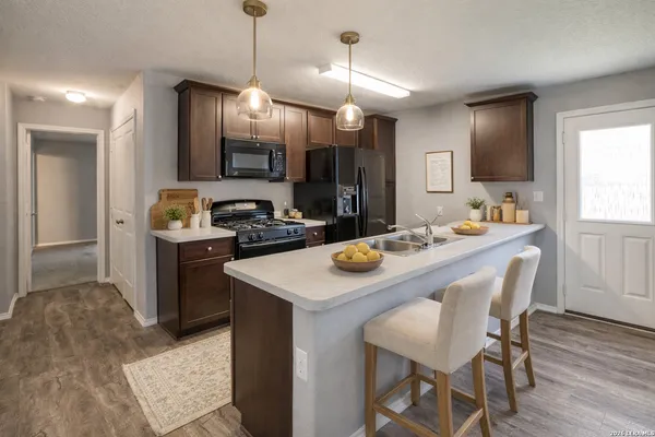 a kitchen with a table chairs stove and microwave