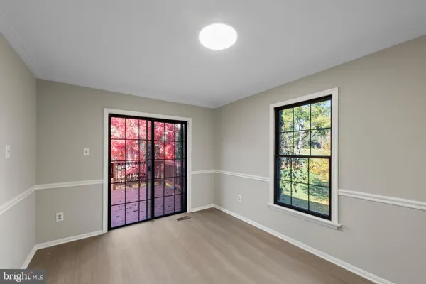 an empty room with windows and closet