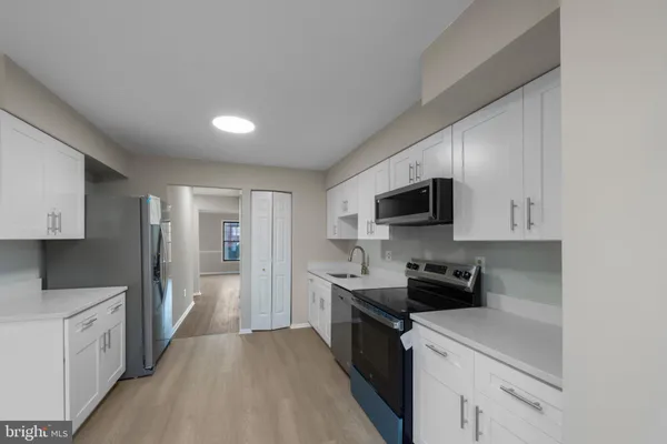 a kitchen with stainless steel appliances a sink dishwasher stove top oven and refrigerator