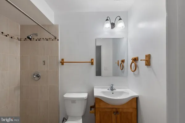 a bathroom with a sink toilet a shower and a mirror