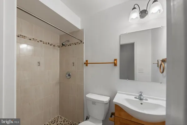 a bathroom with a toilet sink and shower