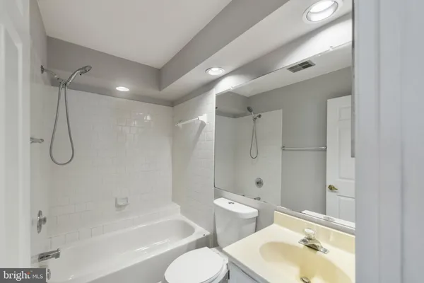 a bathroom with a sink toilet tub and shower