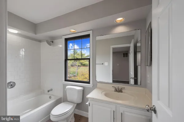 a bathroom with a bathtub and window